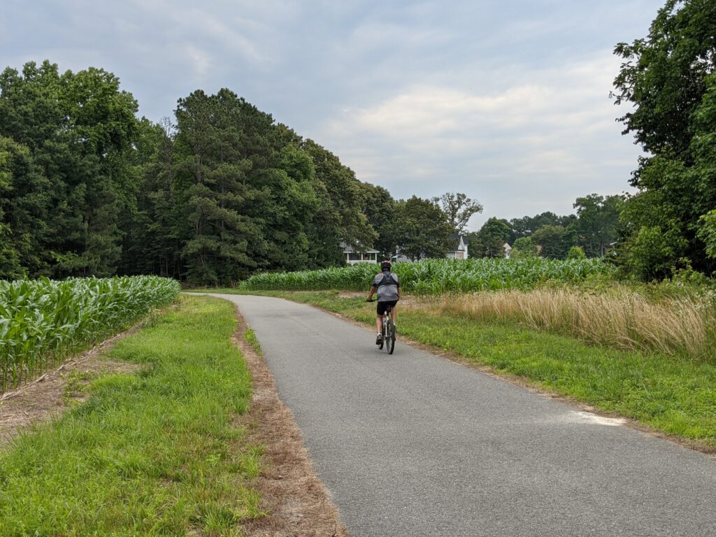 Cyclist riding down a bike trail in a rural part of Central Virginia.
