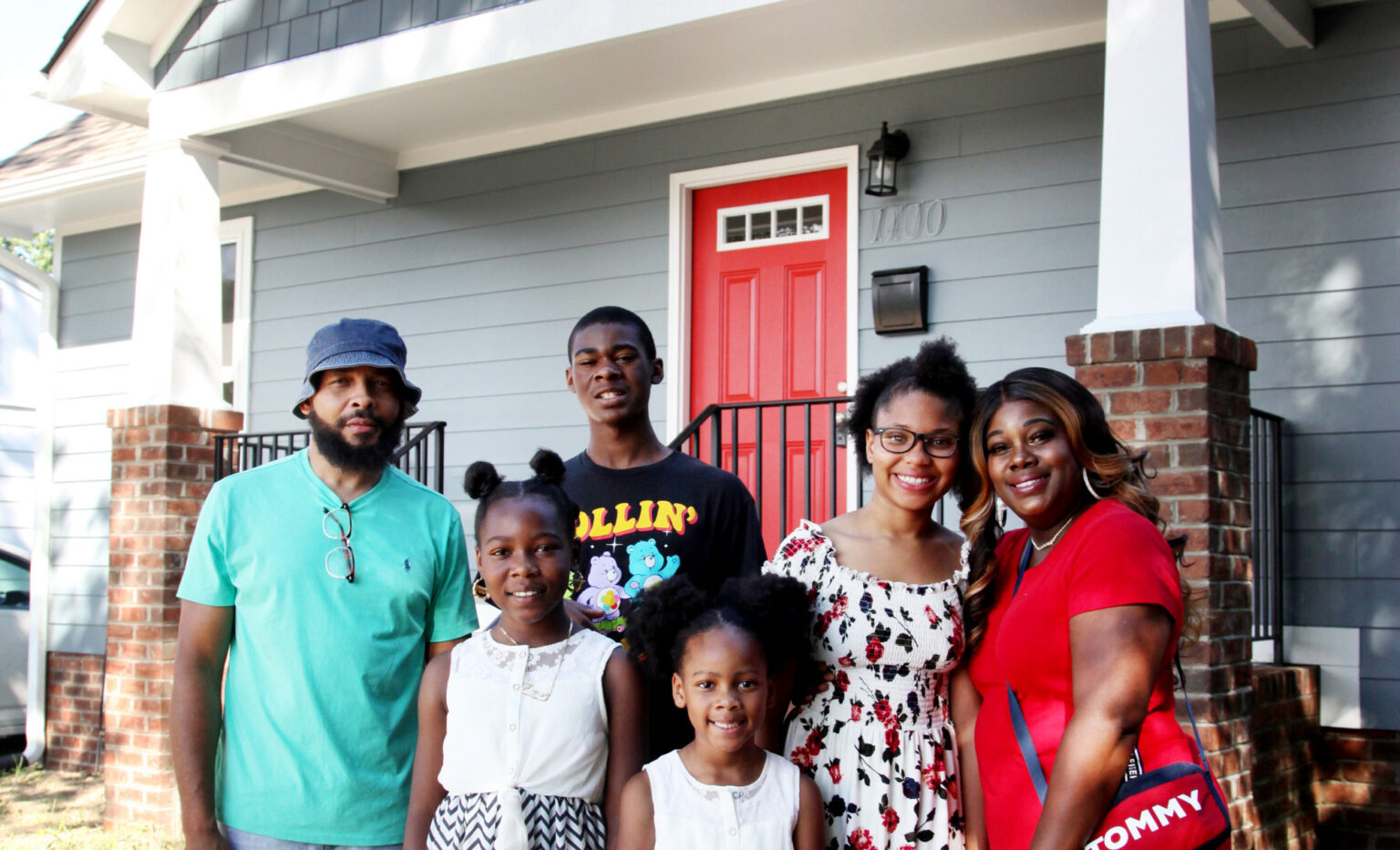 The Adams family standing in front of their new home built by the Richmond Metropolitan Habitat for Humanity. This photo was sourced from a BizSense article, courtesy of Rebecca D'Angelo.