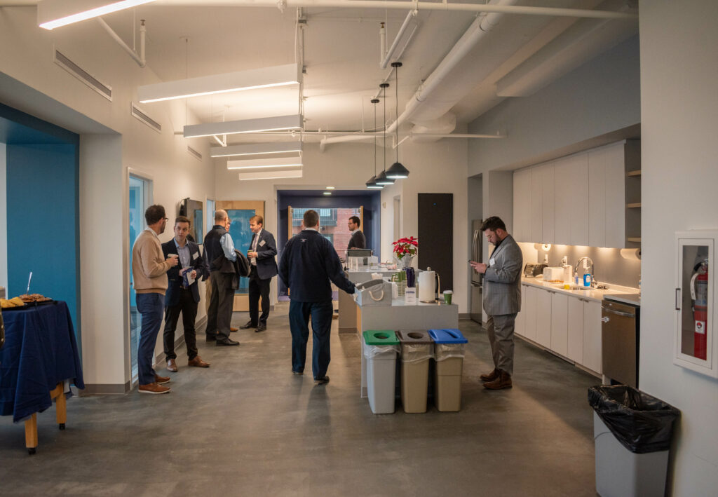 Guests networking in the kitchen during the First Look event at the new PlanRVA office space. 